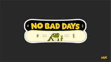 Load image into Gallery viewer, View from the front - Two snowboards overlapping one another (one white and one tan/yellow). The top board says &quot;no bad days&quot; in yellow writting, with NBD and Dolos on the ends. The tan board has an image of a frog&#39;s head and shoulders with suspenders. NBD and Dolos are written on the sides.
