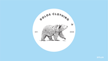 Load image into Gallery viewer, View from the front - A white sticker with a black bear happily following a butterfly. The sticker says Dolos Clothing on top, and Est. 2020 on the sides
